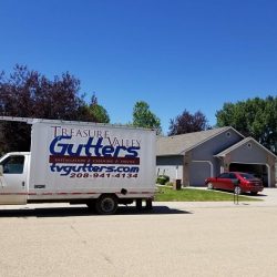 treasure Valley Gutters parked in front of home with red car